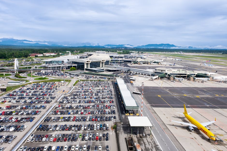 Dynamic aerial perspective of Milano Malpensa Airport showcasing terminal activity and bustling airplane operations.